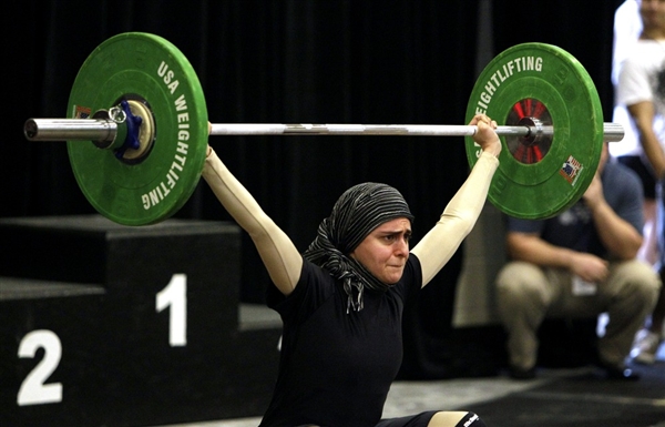Photo caption: Muslimah weightlifter Kulsoom Abdullah at the USA National Weightlifting Championships last summer.  Photo credit: http://msnbcmedia.msn.com